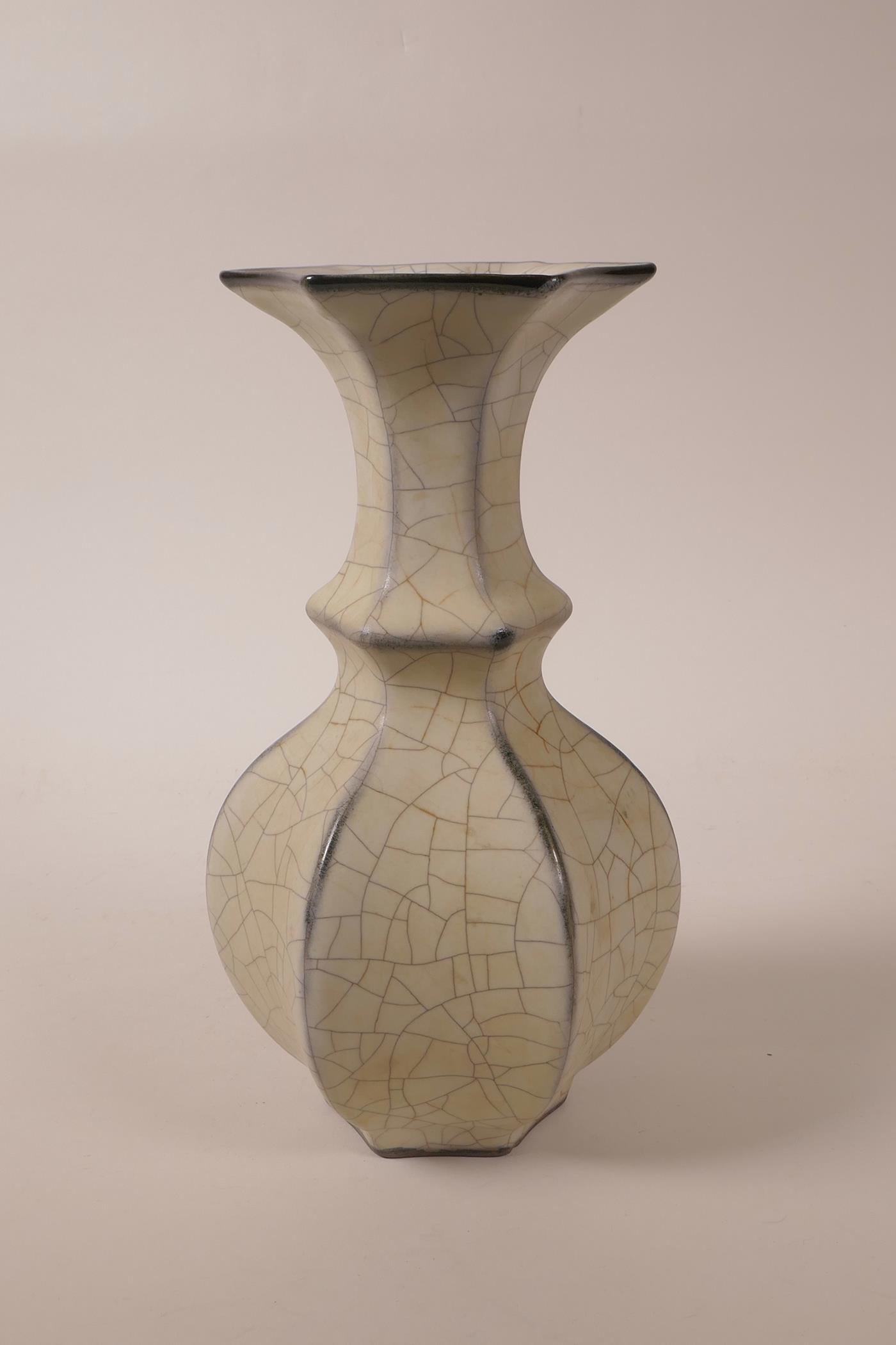 A Chinese cream crackle glaze pottery vase of hexagonal form, raised character marks to base, 9"