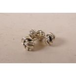 A pair of sterling silver cufflinks in the form of knots
