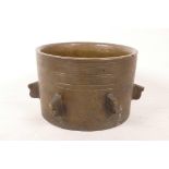 A bronze mortar with six lugs, 4" high x 5½" diameter