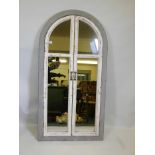 A painted and distressed wood arched window mirror, 30" x 57½"