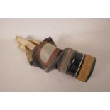 A WWII British civilian gas mask, stamped Poppe Lot 7796, dated 5.1.40, small, A/F