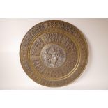 An Oriental brass and white metal charger embossed with Hindu deities, 21½" diameter