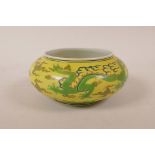 A Chinese polychrome porcelain bowl with green dragon decoration on a yellow ground, 6 character