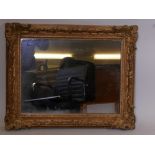 A C19th giltwood and composition picture frame fitted with a mirror, 31" x 25", rebate 18½" x 24"