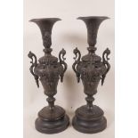 A pair of Victorian spelter side urns decorated with masks and swags, mounted on turned wooden