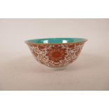 A Chinese polychrome porcelain rice bowl with iron red lotus flower decoration, seal mark to base,