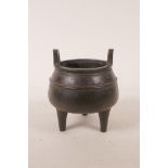 A Chinese bronze censer on tripod supports with two handles, impressed character marks to base,