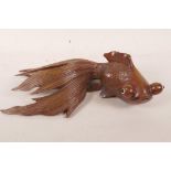 An Oriental carved rosewood figurine of a goldfish with glass eyes, 12" long