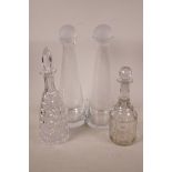 Two contemporary conical glass decanters with frosted glass stoppers, 14" long, together with a