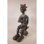 An African carved and painted wood maternity figure of a mother and child, 22" high