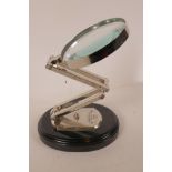 A table top magnifying glass with adjustable chromed stand on an oval wooden base, mirror 5"