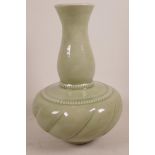 An Oriental porcelain vase with all over green celadon glaze, 13" high