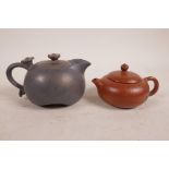 A Chinese pottery teapot with an iridescent charcoal glaze, together with a smaller Yixing teapot,