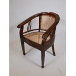 A bow back desk chair, with caned back and seat