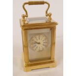 A miniature brass cased carriage clock decorated with Sevres style porcelain panels and painted face