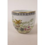 A Chinese polychrome porcelain tea bowl decorated with ducks and flowers, 4 character mark to