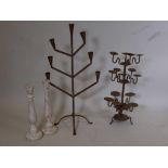 A cast iron, seven branch candelabra, a three tier, multi branch pricket candelabra, and two painted