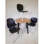 A pair of mid century easy chairs with loose cushions and covers, raised on castors