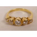 An 18ct yellow gold set five stone diamond half hoop ring, with approximately ¼ct central stone