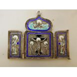 A C19th Russian silver and enamel triptych pendant, the central panel depicting the crucifixion,