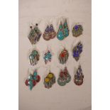 A collection of twelve pairs of Tibetan white metal and hardstone set drop earrings