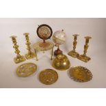 Two pairs of C19th brass candlesticks, two trivets, two desk globes, an ashtray and plates,