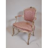 A late C18th/early C19th open armchair, with shaped back and carved decoration, later painted and