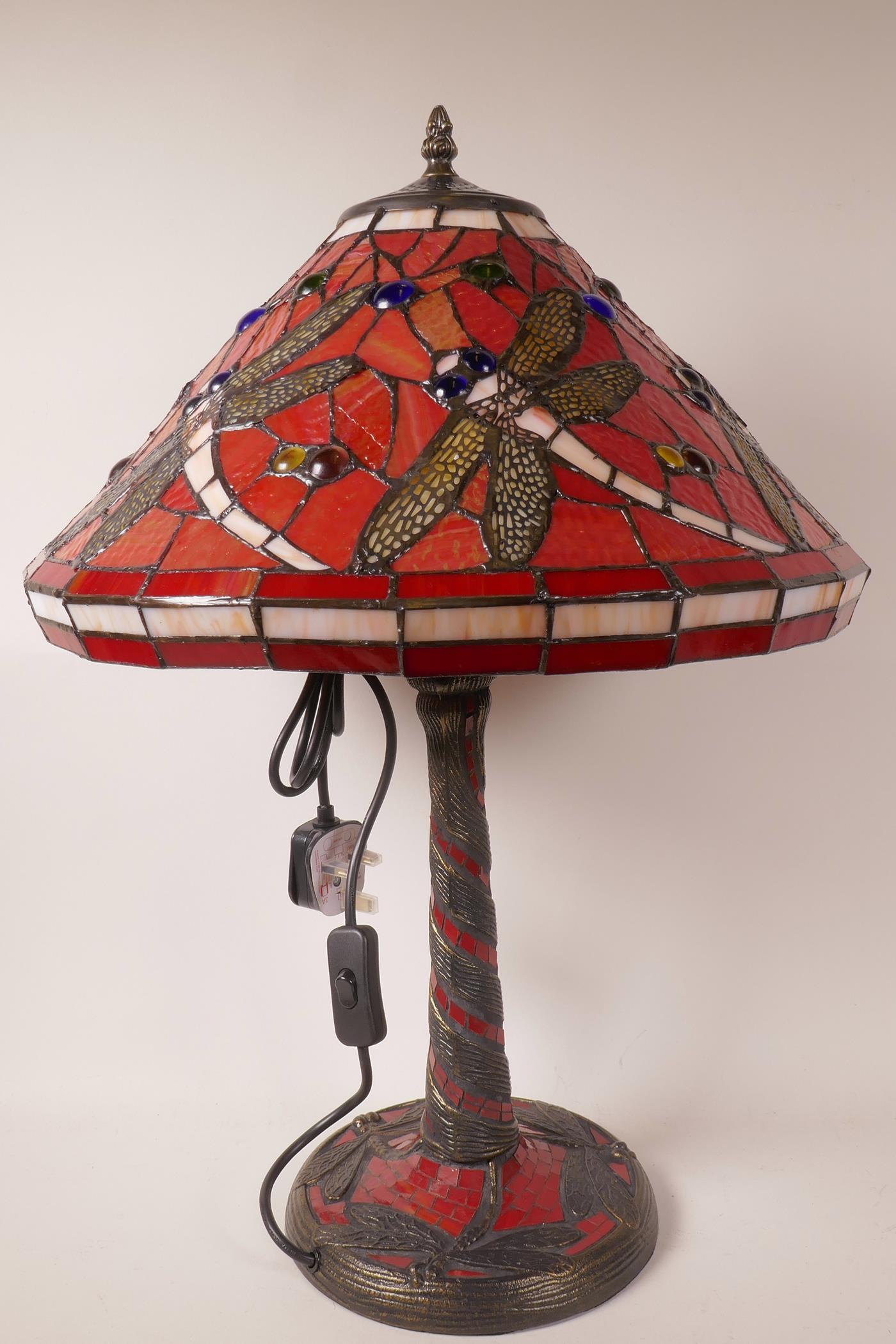 A Tiffany style table lamp with dragonfly decoration on a red ground, 21" high