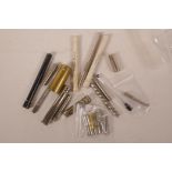 A collection of various metal needle, pen nib and pencil refill cases