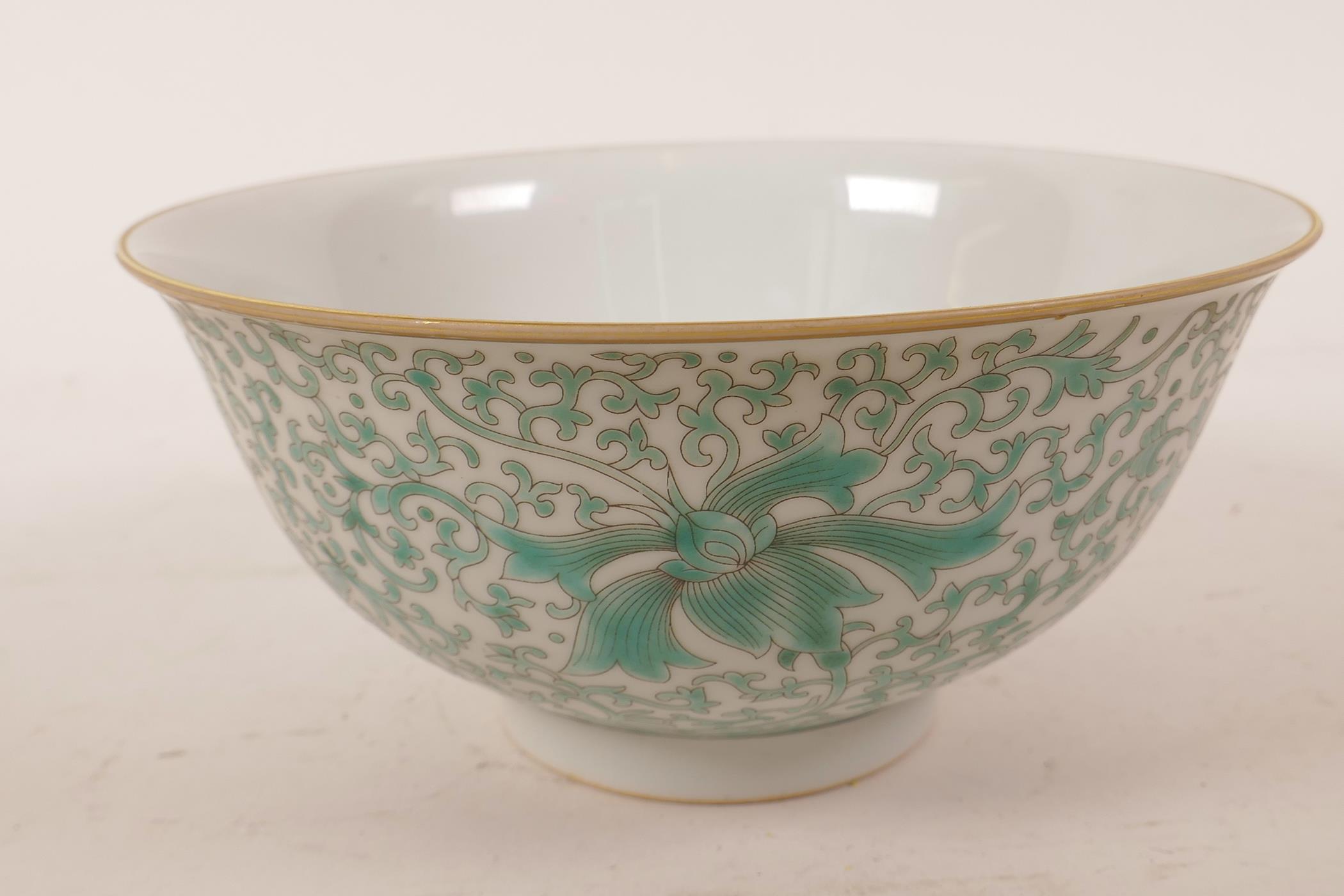 A Chinese porcelain rice bowl with green enamel scrolling lotus flower decoration, 6 character