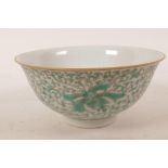 A Chinese porcelain rice bowl with green enamel scrolling lotus flower decoration, 6 character