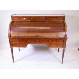 An early C19th French Directoire mahogany cylinder top desk, with marble top and pierced brass