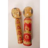Two Japanese turned wood dolls, painted with flowers, 9½" high
