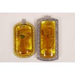 A Chinese faux amber pendant and another similar, largest 1½" x 3"
