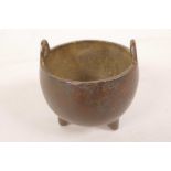 A Chinese bronze cauldron shaped censer, impressed mark to base, 2" diameter