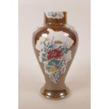 A Chinese polychrome porcelain vase with decorative floral panels within a brown lustre surround,