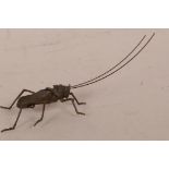 A Japanese bronzed metal Jizai style articulated figurine of a grasshopper, 5½" long