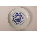 A Chinese blue and white porcelain dish decorated with a central dragon and a sang de boeuf glazed