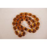 A string of faux amber beads, 34" long
