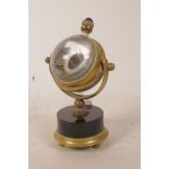 A brass mounted glass ball desk clock with skeleton movement, 5½" high