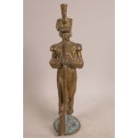 A brass figurine of a C19th infantry officer holding a musket, 12" x 3½"