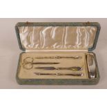 A hallmarked silver manicure set by Sampson Morden, hallmarked Birmingham 1858, in a fitted faux