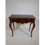 A Louis XV style marquetry inlaid Kingwood, shaped fold out top card table raised on shaped