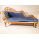A Victorian walnut chaise longue, with carved and pierced back, raised on turned supports, 76" x 42"