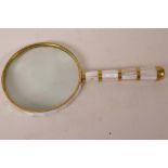 A brass and mother of pearl magnifying glass, 4" diameter