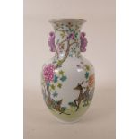 A Chinese polychrome porcelain two handled vase decorated with deer in a landscape, seal mark to