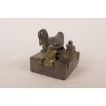 A Chinese filled bronze seal with smaller seals inset to the top, decorated with a duck and