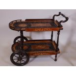 An Oriental carved and inlaid drinks trolley, 28" high, 30" long