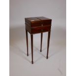 A George III mahogany workbox, with fold out top and fitted interior, over a single drawer, raised