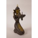 A Sino-Tibetan filled gilt metal figure, kneeling and holding a lotus flower, indistinct mark to